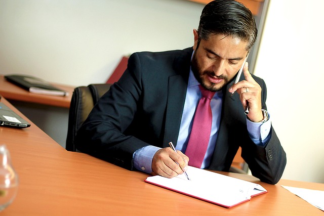 Attorney and client discussing legal documents at a desk.