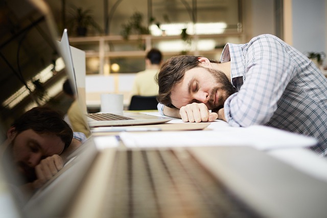 Employee looking stressed at a desk with a resignation letter, symbolizing the forced decision to leave due to intolerable work conditions, representing constructive dismissal. (what is constructive dismissal)