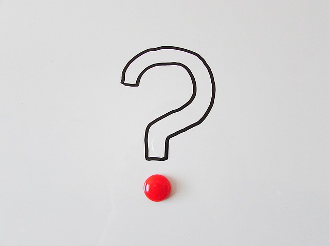 Graphic of a handshake with a question mark above it, symbolizing the uncertainty of oral agreements. (oral contracts enforceability explained)