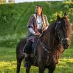 person riding horse at night